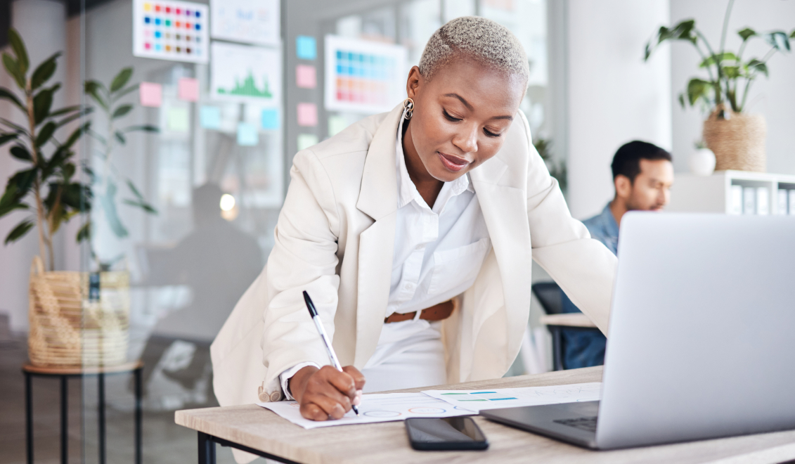 Woman standing while working at a desk in a contemporary office setting