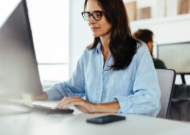 Woman taking the LPI assessment on a desktop computer.