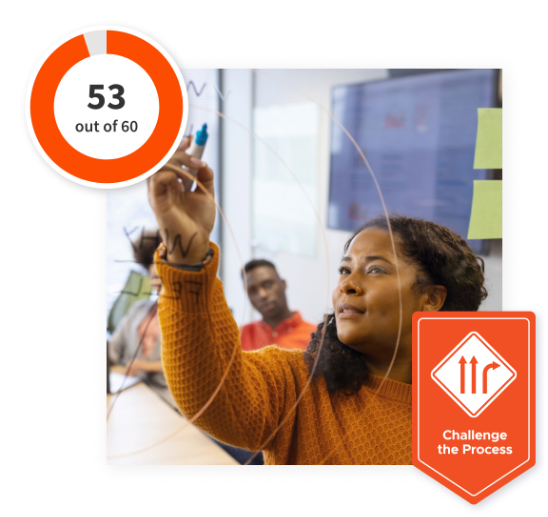 Woman in a meeting writing on a board with an orange ‘Challenge the Process’ banner at the bottom and a 53 out of 60 scale in the top left corner.